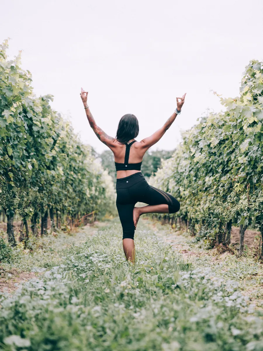 Woman stretching outdoors in a vineyard