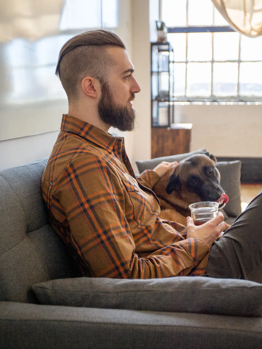Man relaxing on the couch with his dog